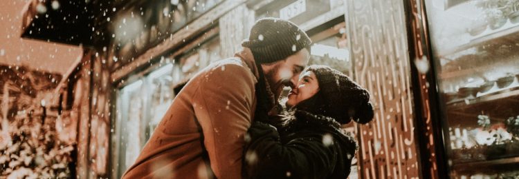 kissing amid snowfall flowershop