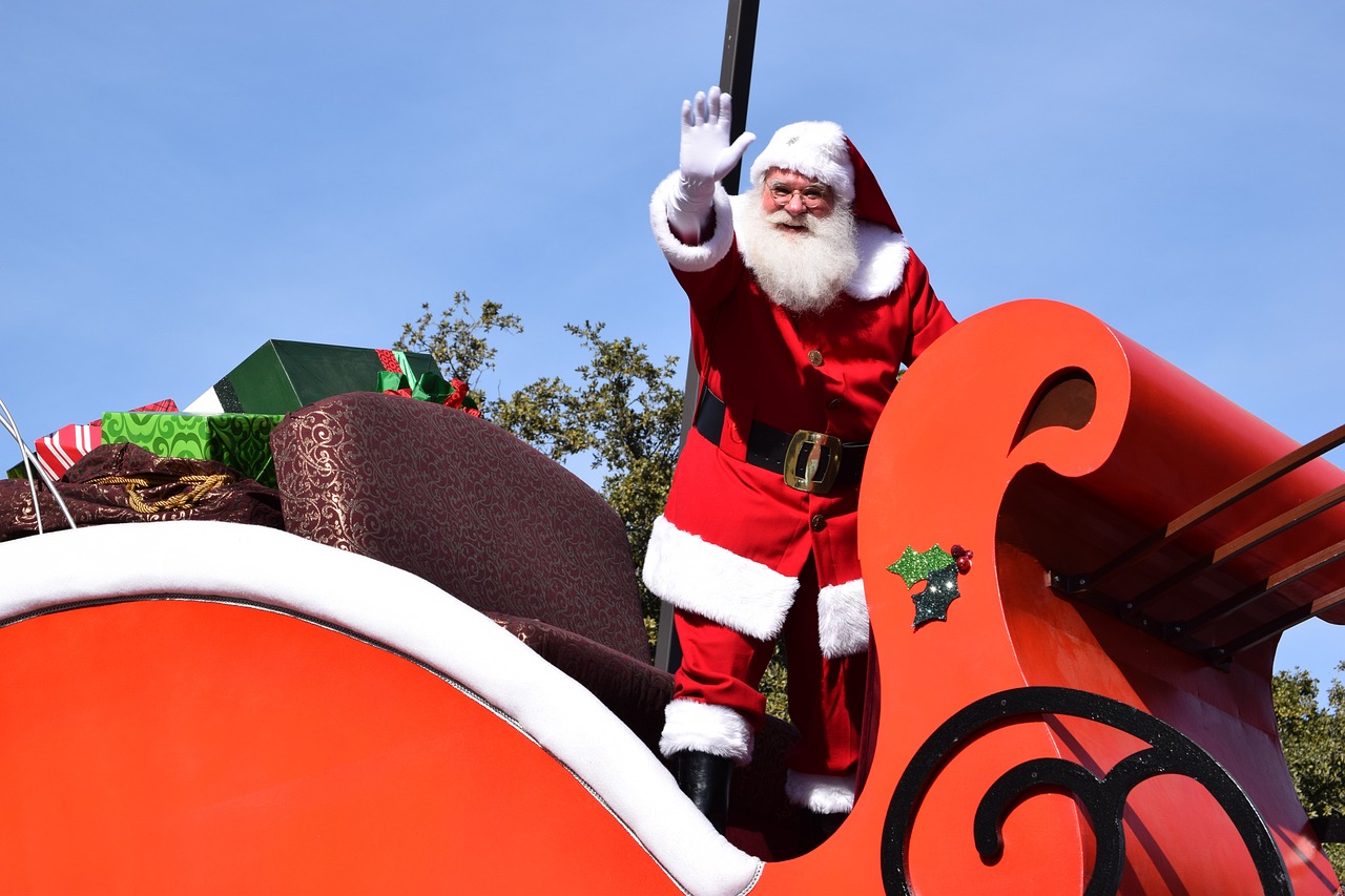 Santa riding upon a Christmas parade float of his sleigh
